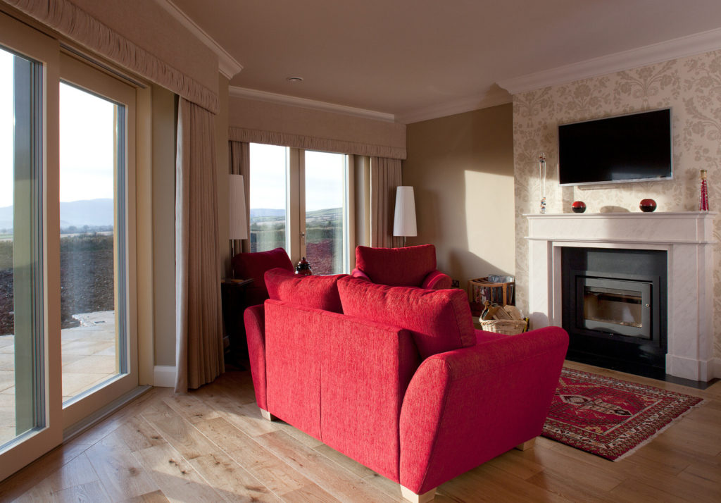 A comfortable living room with red sofas in an Irish passive house