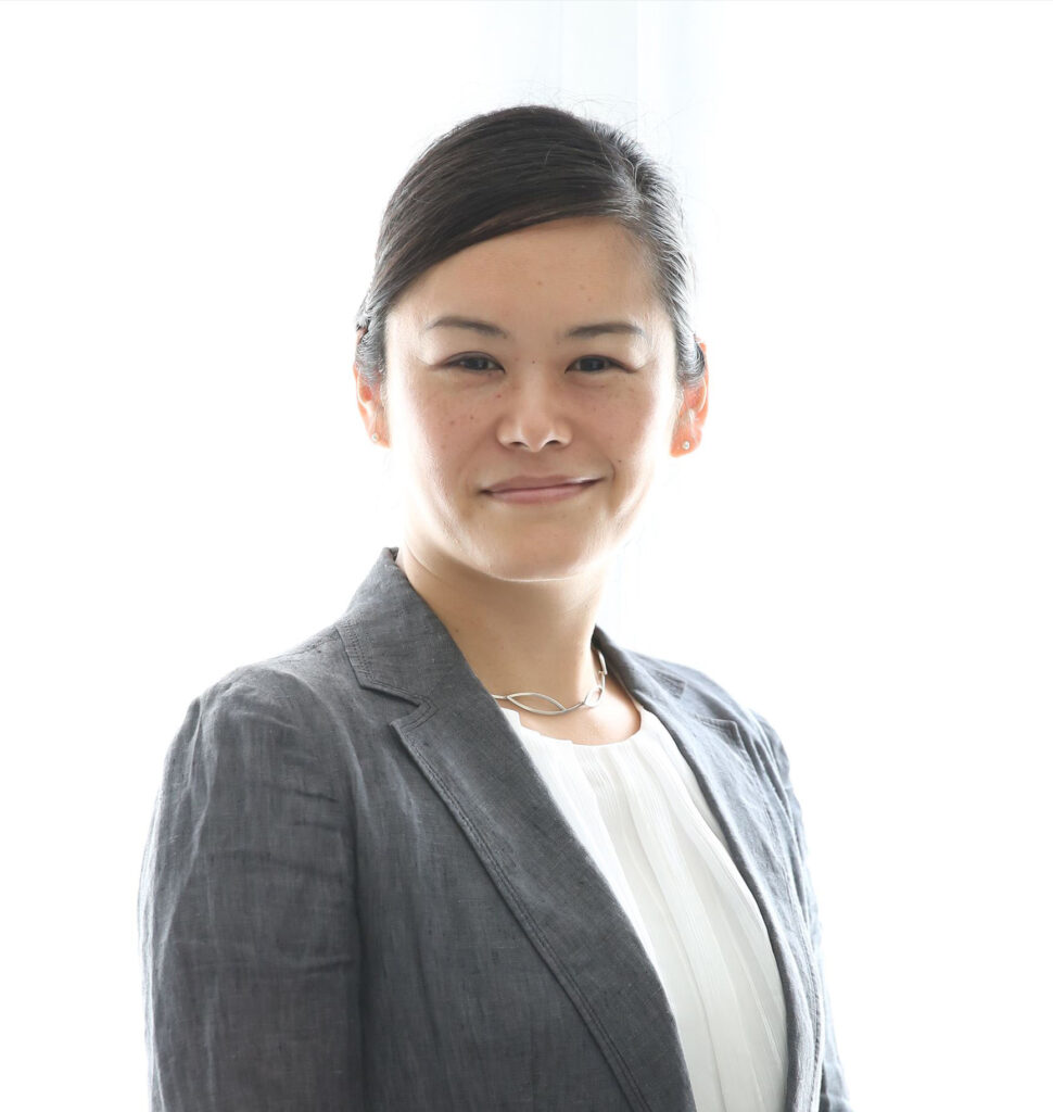 Professional headshot of Miwa Mori. The architect is wearing a grey suit standing before a white background.